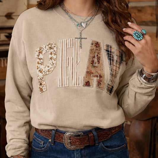 Features bold PRAY lettering with floral and plaid patchwork embroidery. Round neckline and Long sleeves with ribbed cuffs offer cozy winter warmth and relaxed fit. Soft cotton-blend fabric ensures comfort for daily wear or casual outings.
