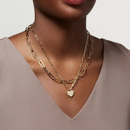 18K Stainless Steel Waterproof Tarnish Free Multi-Layer Heart Charm Necklace, made with stainless steel with a luxurious 18K gold finish, this necklace features double layers adorned with delicate heart charms. Its waterproof and tarnish-free properties ensure that it maintains its shine and luster, making it suitable for everyday wear in any conditions. Product Details: Length: 16"Charm size: Ext: 2" ext Clasp: Lobster Claw Metal finish: Stainless Steel 18K Gold Product: Lead & Nickel Compliant Anti-tarnis
