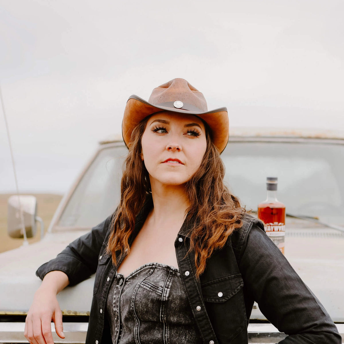 A Unisex Leather Cowboy Hat that offers rugged style with a unique pinched cyclone shape. Crafted from genuine leather and featuring concho accents, this medium-brim hat is perfect for men seeking a bold, durable look for any adventure
